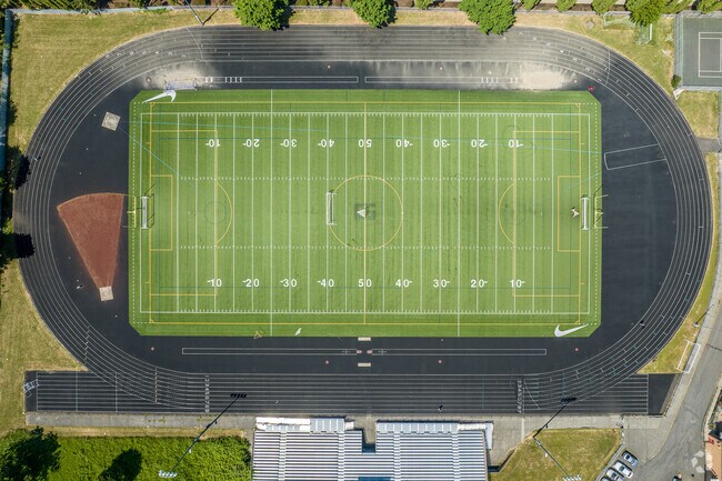 A large track and football field resides behind the Benson Polytechnic High School.