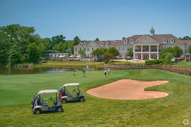 Residents play a game of golf on a beautiful June day in Dominion Valley.