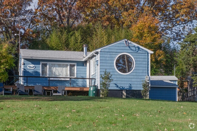 A whimsical round window graces the end of an addition to a ranch home on Prudence Island.