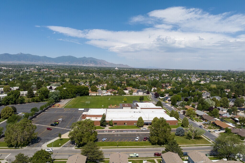 An aerial photo shows Horizon Elementary surrounded by green space, blue skies and mountains.