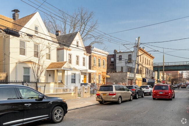 Modest single family homes line the streets of Cypress Hills in classic colonial architecture.