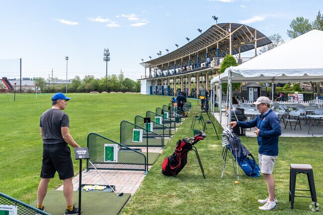 Golfers share tips at the Skokie Sports Park driving range in Southeast Skokie.