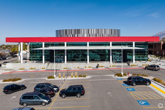 Alta Performing Arts Center is made mostly of glass but is topped with red and gray toned detail