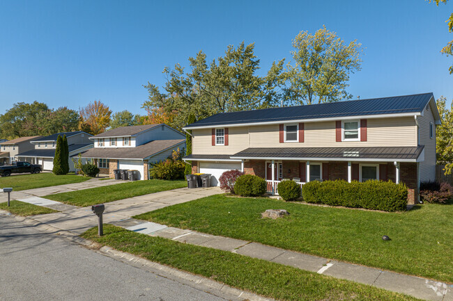 Large Colonial-style homes line the streets of Bullerman Park Forest.