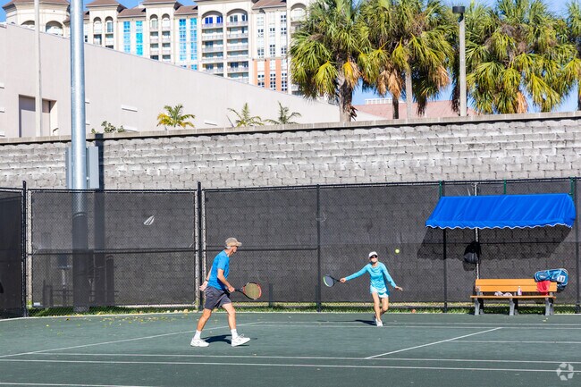 Flamingo Park residents enjoying a challenging game of tennis.