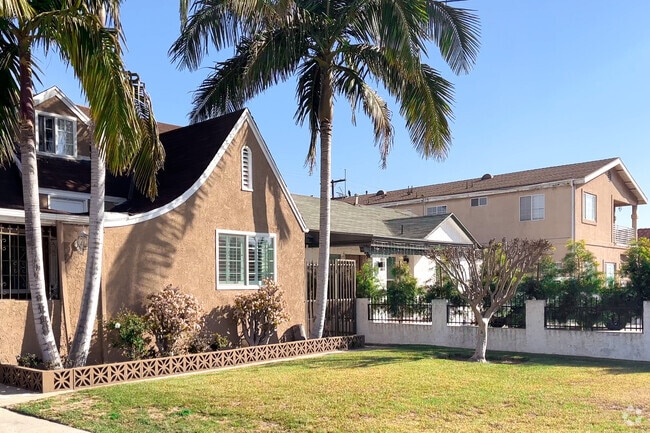 Palm trees frame a Walnut Park ranch-style home.