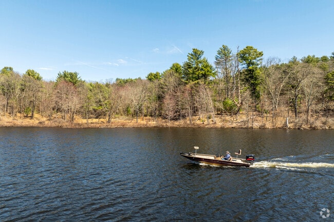 A person enjoys an afternoon boating on Mansfield Hollow Lake.