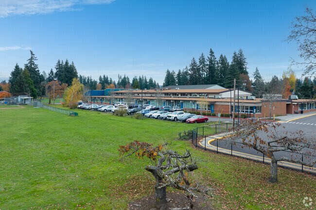 Green space runs by the north edge of Bilquist Elementary School on SE Webster Rd in Portland.