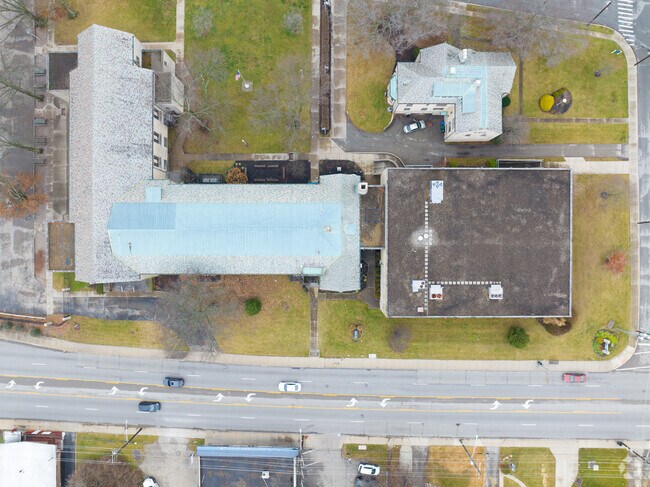 Across the street from the school is  a street with a row of homes.