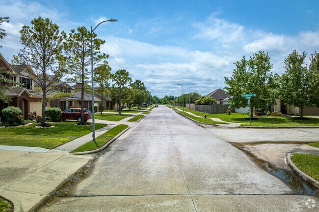 Towering oak trees line the streets,of Brookside Village.