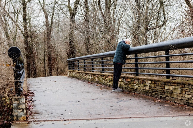 A Young-Lilly resident pauses to enjoy Wilson's Creek from the Wilson's Creek Greenway.