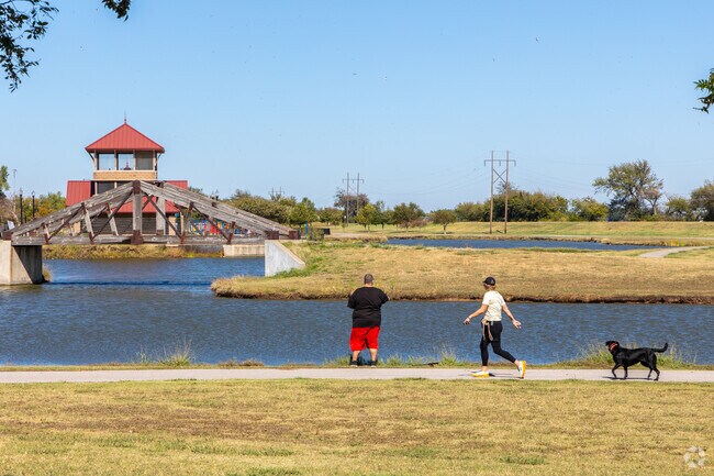 People fish at the local pond near the Cyrus Avery Observation Tower.