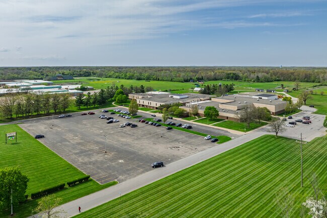 The New Standard Academy features a large athletics area behind the school for student sports.
