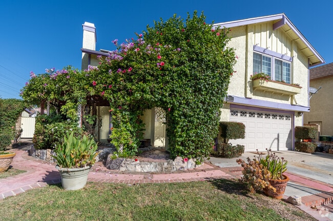 A trellis covered in greenery adds a welcoming touch to this Mission Hills home.