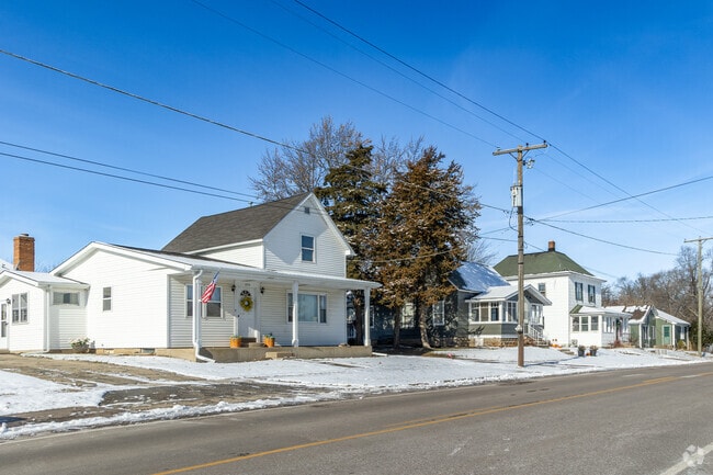 A row of farmhouse-style homes sits quietly in the snow in Burlington.