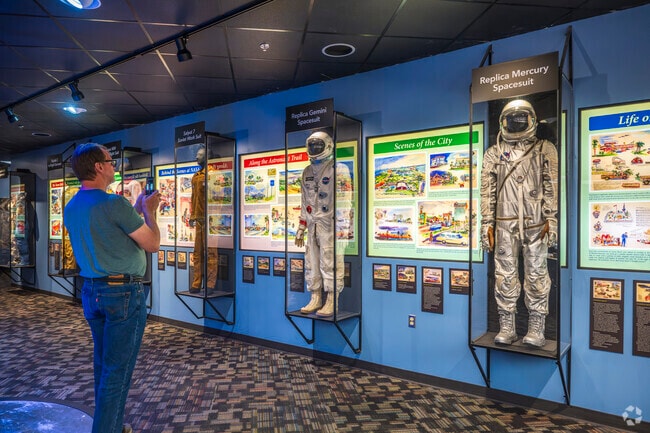 A visitor admires the spacesuits on display at the Museum of Space History and International Space Hall of Fame located in Alamogordo.