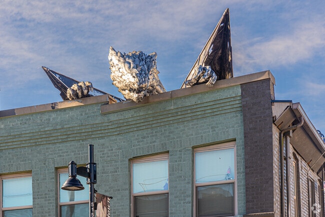 Erasmus, a dragon sculpture, perches atop a historic building in downtown Renton.