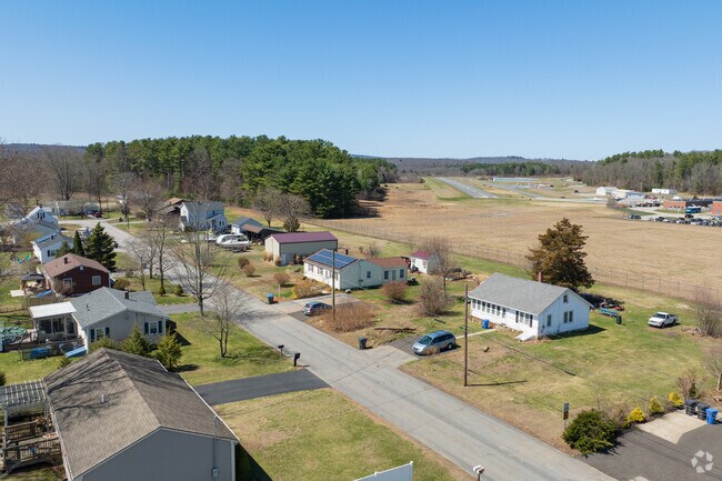 Single-family homes in Danielson line wide, sidewalk-framed streets, offering a peaceful blend of charm, space, and community living.