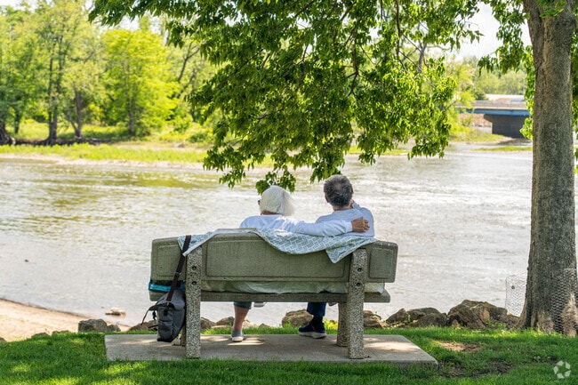A couple enjoys a quiet afternoon under a tree at Oregon Park East in Oregon, IL.