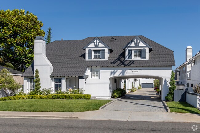This custom beauty boasts a drive-through carport with garage access in the back of the home.
