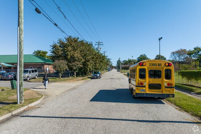 A man passes a schoolbus on the streets of Marshall.