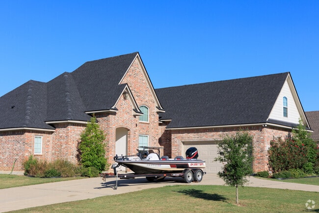 Two story home with brick construction and French country influence.