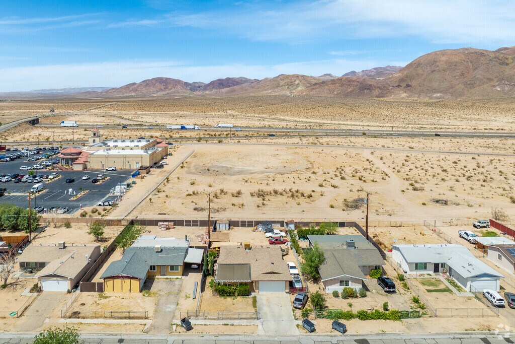 The land in Yermo is flat, with wide dusty roads, and the rolling Calico Mountains in the distance.