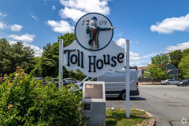 A restored sign of the Toll House Inn, with a commemorative plaque underneath in Whitman.