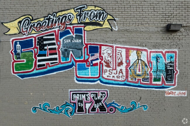 A beautiful mural covers the wall next to the New Generation Barbershop in San Juan.