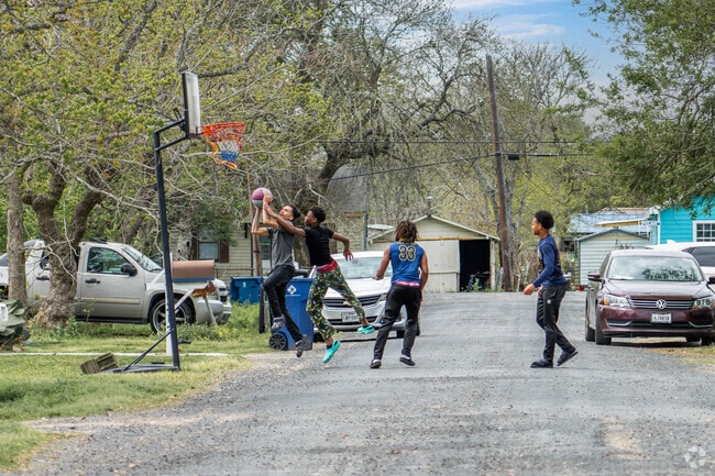 Pickup basketball games are common on quiet streets in La Marque.