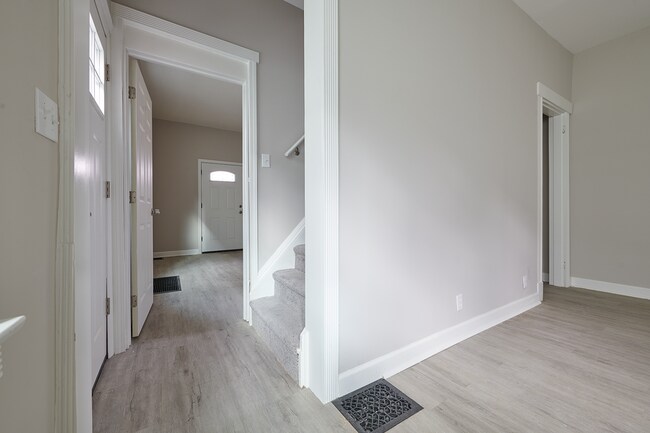 Staircase to second and third bedroom divides first floor bedroom from spacious living room