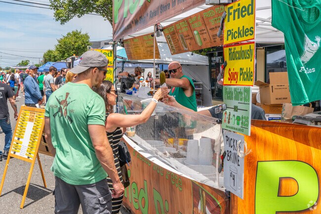 Sink your teeth into a pickle on a stick at the Massapequa Street Festival.