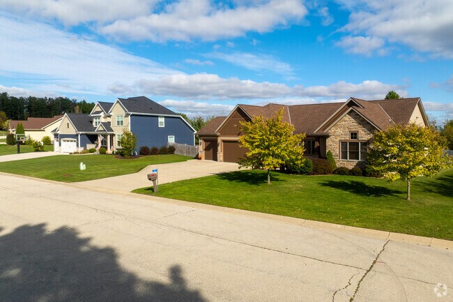 Ranch and Colonial homes line a sidewalk-free street in Eagle Lake.