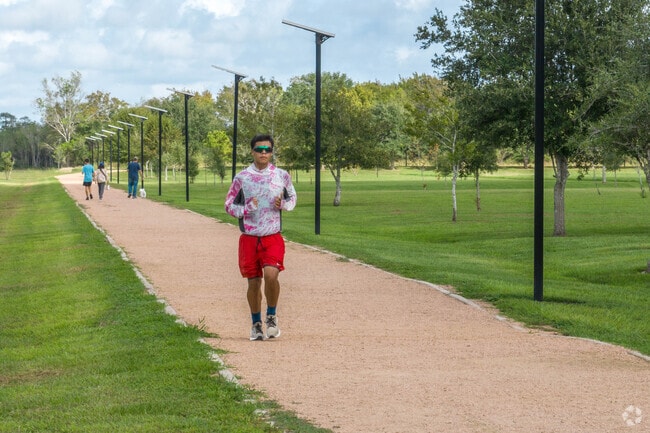 A jogger enjoys the trails at Bates Park in Angleton.