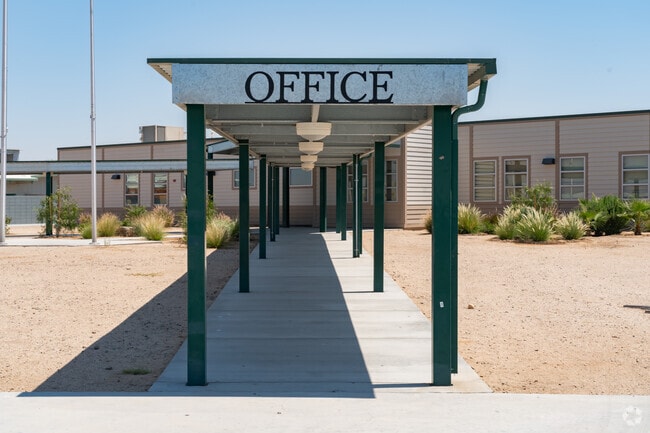 The entrance to the office is through the long passage at the front of the school.