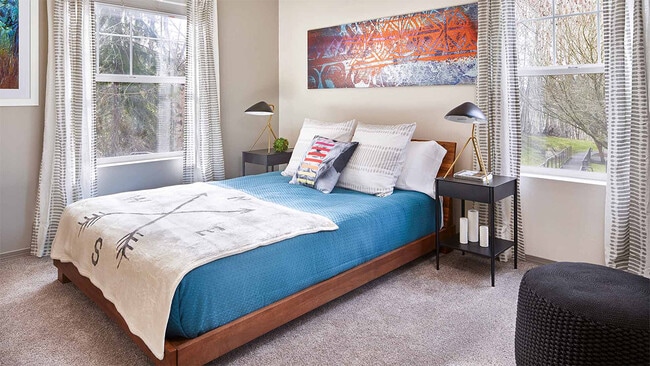 Spacious apartment bedroom with carpeted floors.