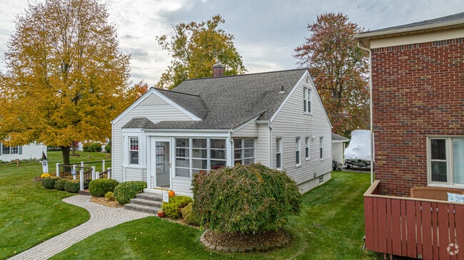 A cozy bungalow with a closed-in front porch is perfect for all seasons in Gibraltar.