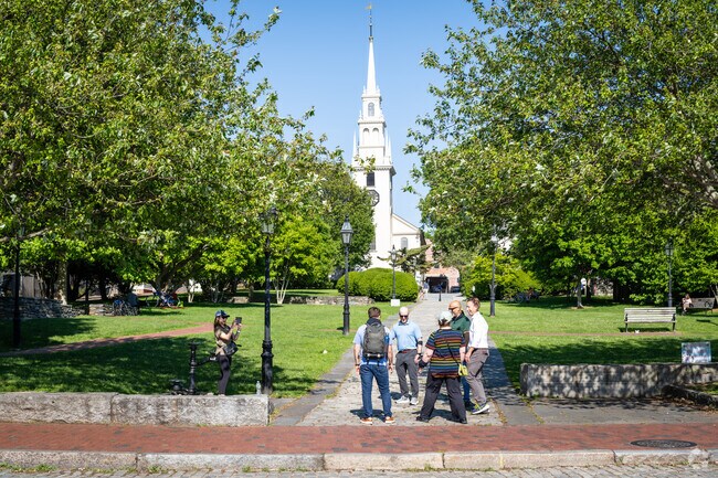 Friends and colleagues gather to enjoy the outdoors at Queen's Ann Square in Newport, RI.