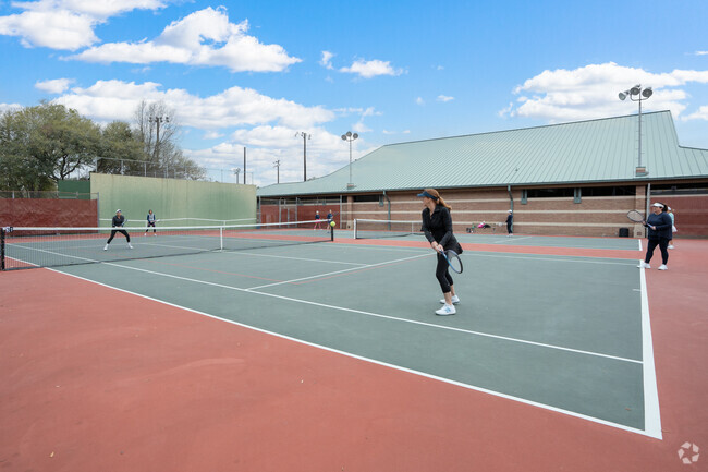Sports facilities, including tennis courts, enhance the park's offerings.