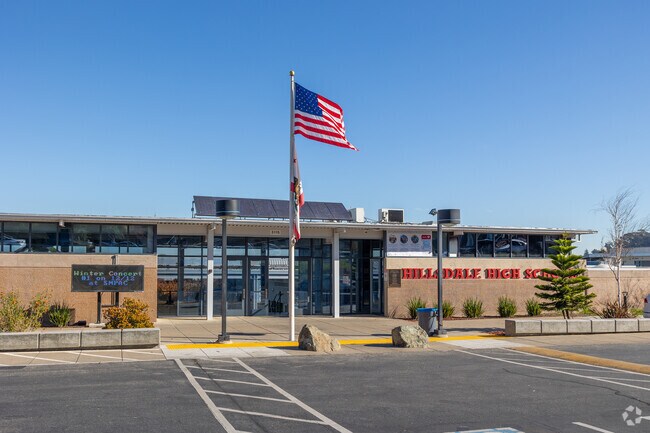 The American flag proudly waves at the front of Hillsdale High School's campus.