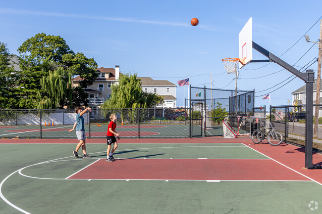 Local residents of Adams Shore play basketball at the Perkins Playground in Quincy, MA.