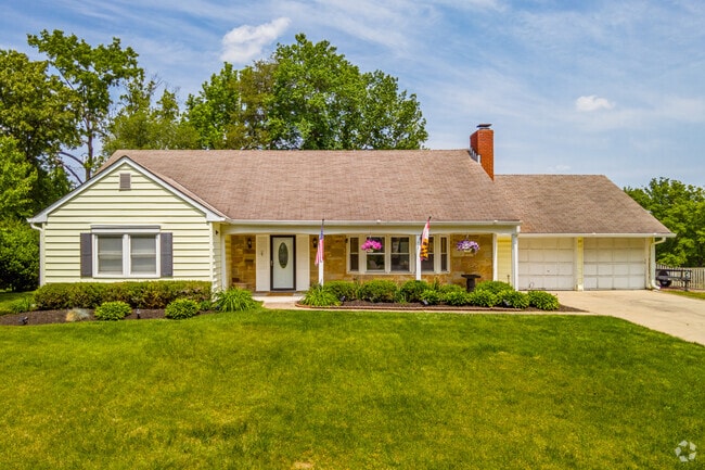Quaint Ranch style home in the South Laurel neighborhood, boasting an attached two-car garage for easy parking.