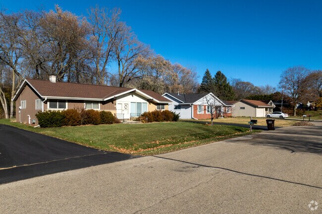 A row of classic mid-century ranch homes lines this quiet Bender neighborhood street, each featuring simple rooflines, attached garages, and the easy suburban charm the area is known for.