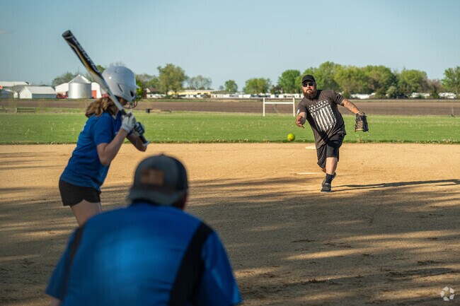 A focused batter prepares to swing at a softball at Big Rock Park District Community Park.