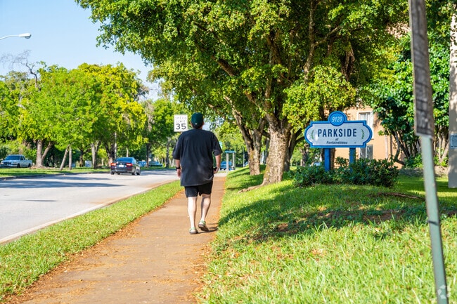 Fontainebleau East residents enjoying a walk on Fontainebleau Blvd sidewalks.