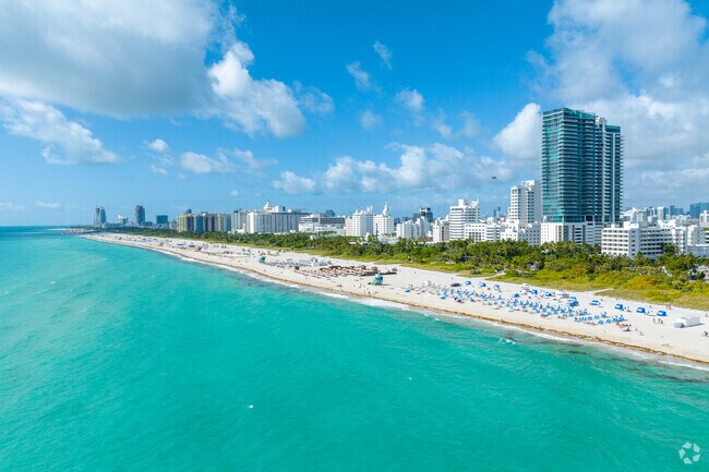 Aerial view of the beach with waterfront condos and hotels in Miami Beach Boardwalk.