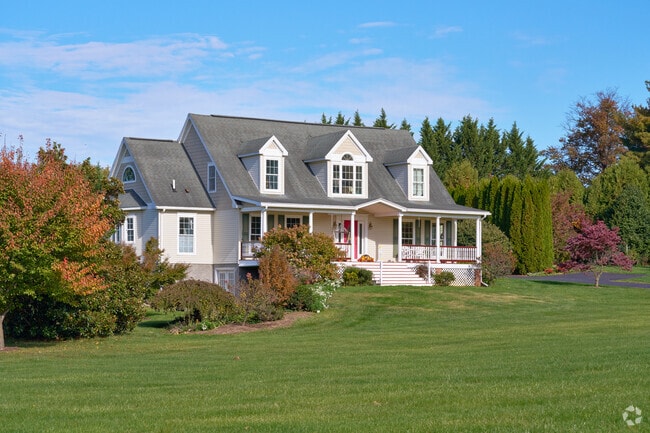 A colonial-style home stands in a rural neighborhood in Ranson.