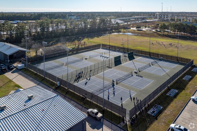 Multiple tennis courts can hold various games at once.