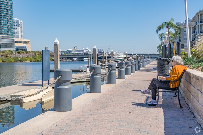 Neighbors of Harbour Island chill out by the benches on the water's edge.