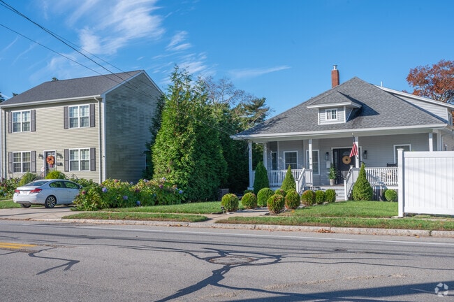 A colonial home stands beside a bungalow home in Freetown.